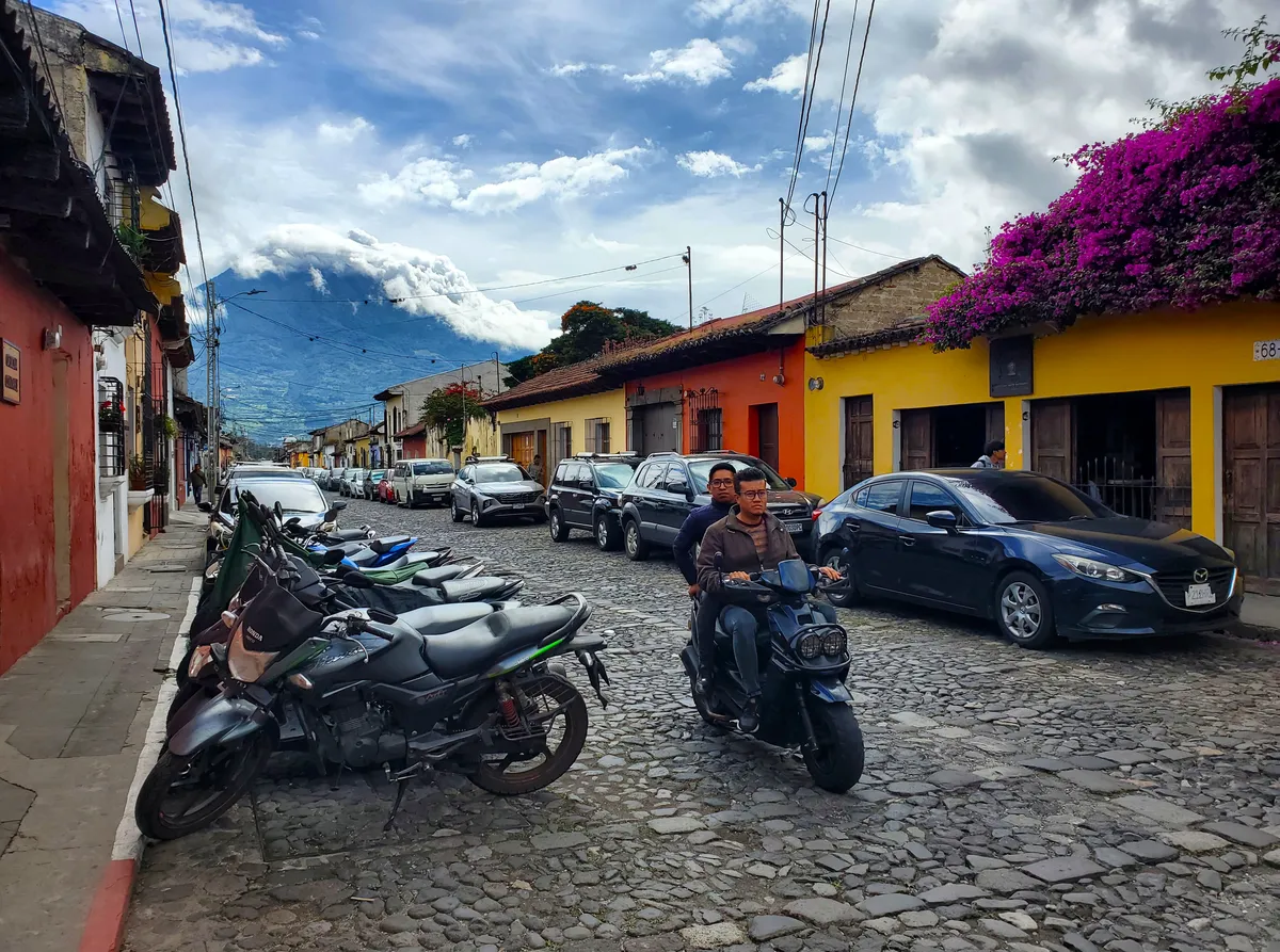 Antigua Guatemala with dramatic volcano backdrop