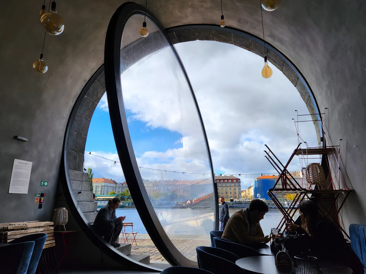 Coffee shop through a stone portal in Prague